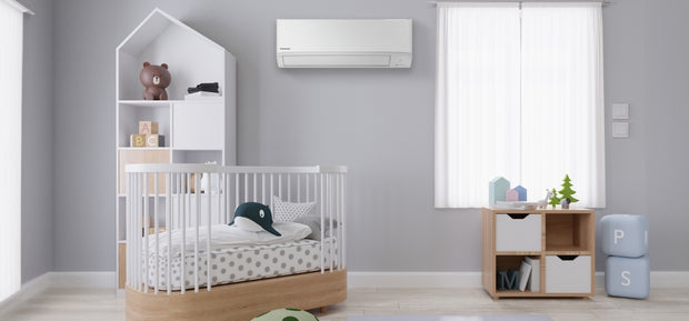 Light gray baby room with a wall-mounted air conditioner unit