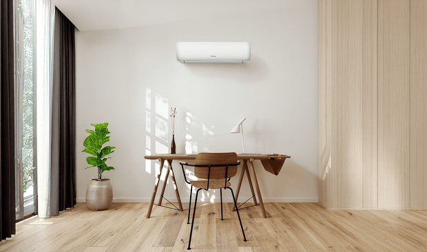 A spacious home office with a wall-mounted air conditioner unit