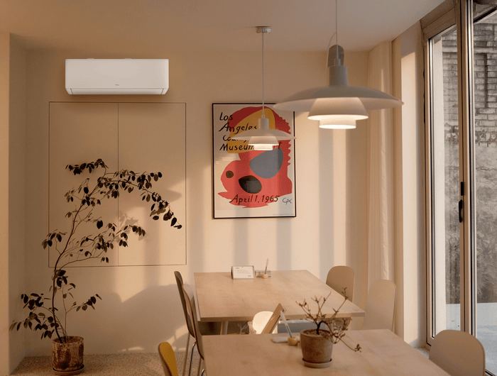 A moody dining room with a white TCL air conditioner unit on the wall