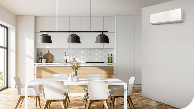 A modern open kitching and dining area with a wall-mounted air conditioner unit